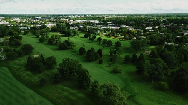 Aerial drone shot over a beautiful Golf club in Northbrook Illinois, USA in a town on a cloudy day.