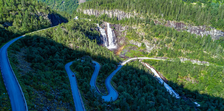 Skjervsfossen waterfall, on the road between Granvin and Voss, Vestland, Norway. Impressive beautiful win falls plunging 150 metres in a narrow canyon