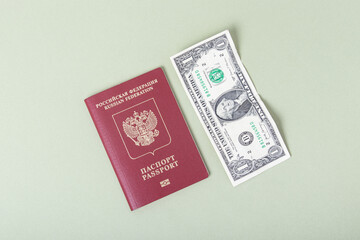 Russian foreign passport and one dollar on green background. Currency exchange