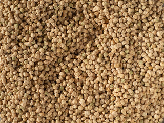 Background of the pea texture from the top view. The texture of a natural food background from pea seeds. Close-up of the surface of a large number of dry pea grains with texture