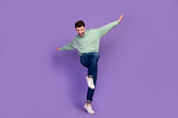 Full length body photo of young man wear trendy outfit hands up carefree relax excited positive mood dancing nightclub isolated on violet color background