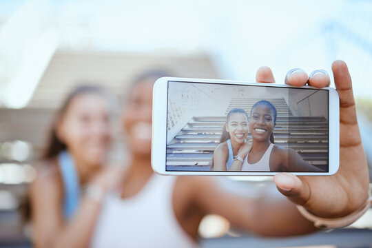 Selfie, phone and fitness with girl friends taking a photograph during a workout, exercise or training. Sports, wellness and health with a black woman and friend posing for a mobile picture