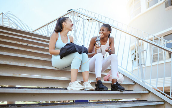 City Fitness, Relax And Friends On Stairs After Running For Cardio With Water Together In Australia. African Runner Women With Smile, Laughing And Happy After Outdoor Workout And Exercise Training