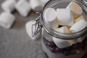 Mason Jar filled with mix for hot chocolate and marshmallow for a gift or treat