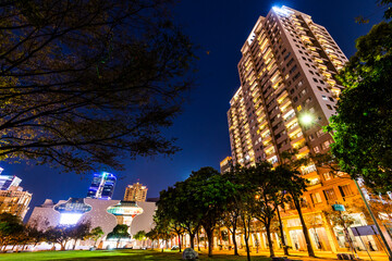 Night view of the National Taichung Theater and surrounding modern buildings in Taichung, Taiwan.
