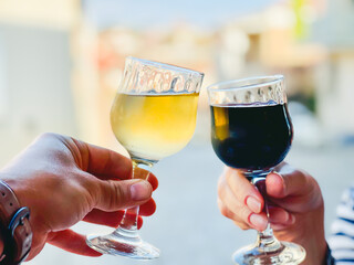 Crop couple clinking glasses of wine