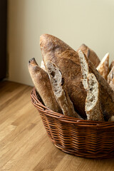 Homemade sourdough baguettes in a wicker basket