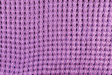 Violet wool knitted textured background close up. Handmade knitted fabric violet wool background texture.
