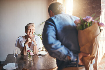 Elderly, couple and flowers on a date for surprise, love and romance in their house. Senior woman,...