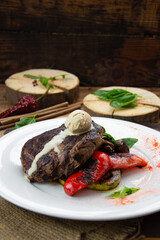 Big steak with sauce in the form of a scoop of ice cream