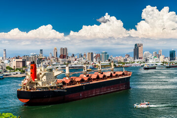 The large ship is sailing into the Port of Kaohsiung, Taiwan.