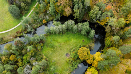 forest and river at sunset in autumn. Aerial view of wildlife in Latvia, Europe