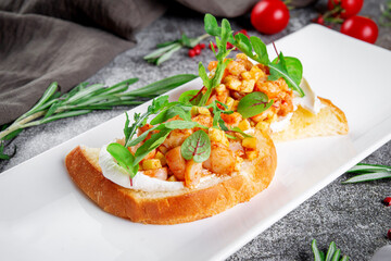 Delicious snacks. Toasted croutons with squid. Bruschetta with seafood and lettuce