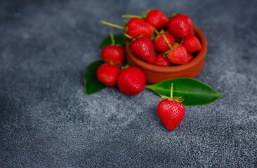 Fresh organic strawberries , over dark background. Vegetarian healthy food concept.