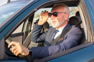 Senior businessman driving car and stuck in traffic jam - 535781862