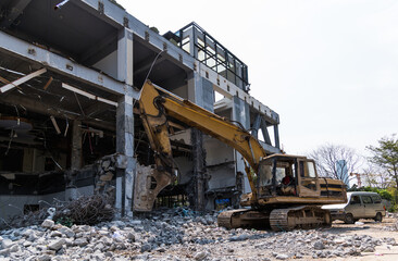 Excavator working on building demolition site