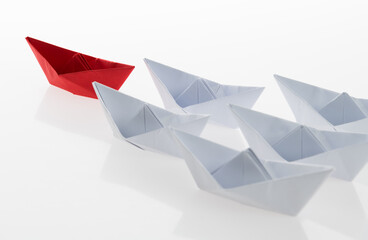 The red origami boat is leader