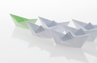 The green origami boat is leader