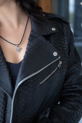 Cropped close up portrait of young woman with perfect silky skin, demonstrating silver jewelry...