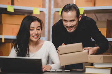 Obraz premium Asian woman e-business entrepreneur checking order and packing parcel box of product shipping delivery business, freelance marketing owner having online cyberspace to work with logistic package job