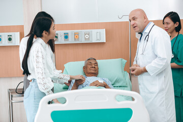 Obraz premium professional doctor standing by explain the treatment information via male elderly patient lying in bed in private hospital sickroom. The treatment program is suitable for people to socialize elderly