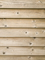 Wooden plank wall background, horizontal layered exterior planks with light wood grain texture