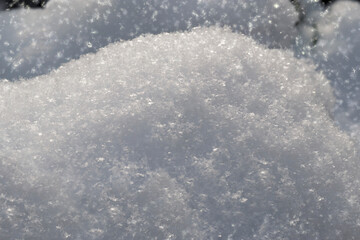 Texture of fresh, clean, sparkling, freshly fallen snow. Fallen snow sparkles in sun. Winter background. Background for design of Christmas and New Year themes