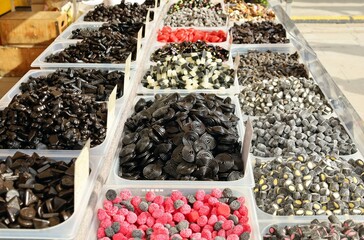 Large shelf full of licorice candies and rolls in the confectionery store