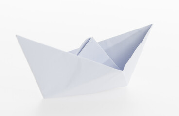 White origami boat on white background