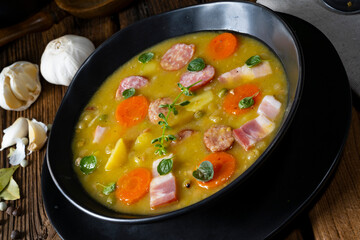 Hearty rustic pea soup with bacon and sausage