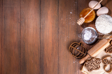 Autumn baking flat lay with pie ingredients, cookie cutters in the shape of a leaf, pumpkin, symbols of autumn, pumpkins and apples on a dark cozy wooden background copy space