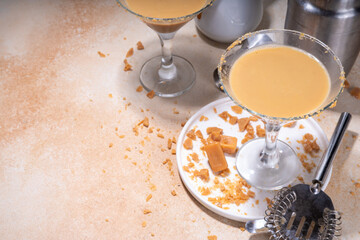 Salted caramel creamy martini drink. Sweet and salty caramel cocktail, with toffee candies, copy...
