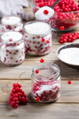 Schisandra chinensis jam on wooden table. Five-flavor berries with sugar in a glass jar
