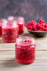 Schisandra chinensis jam on wooden table. Five-flavor berries with sugar in a glass jar