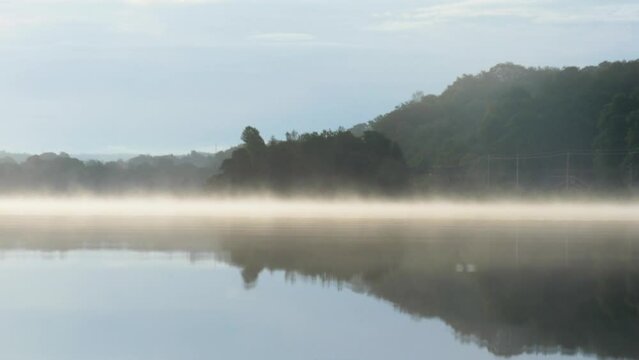 Slowmotion shot of morning fog on the water surface on a lake in Sweden..