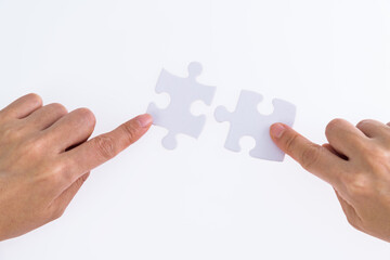 People hand connect two couple puzzle pieces