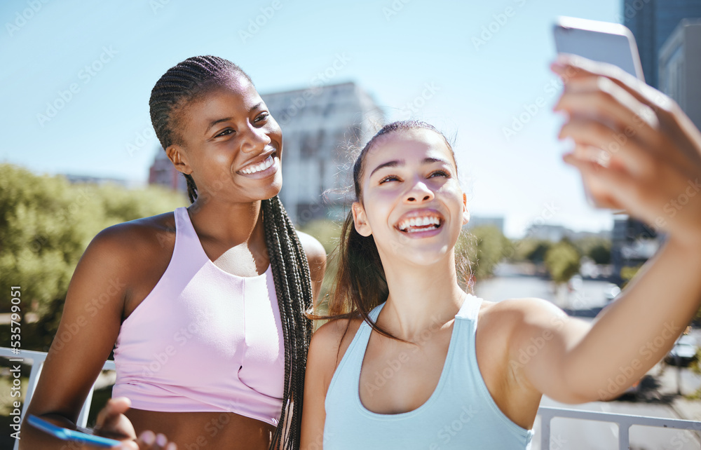 Wall mural Fitness, woman and friends for phone selfie in exercise, training or workout together outside in the city. Active female in friendship smile for fun cardio or sports photo with mobile smartphone