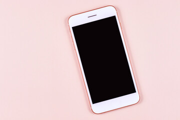White phone smartphone with black screen lies on a pastel pink background. Good quality