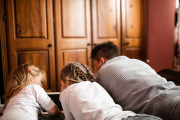 Father playing and joking with his daughters in bedroom
Cozy time wih father
Father daughter time