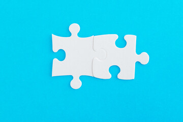 Two puzzle pieces on blue background