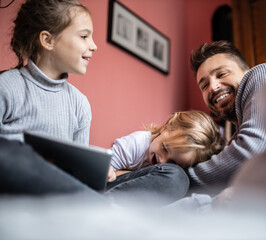 Father playing and joking with his daughters in bedroom
Cozy time wih father
Father daughter time