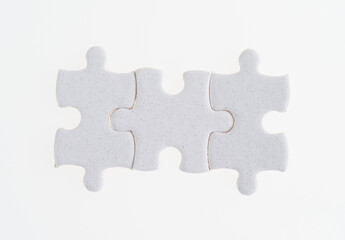 Three puzzle pieces on white background