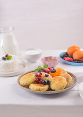 Cheesecakes with fresh berries on a table with a white tablecloth