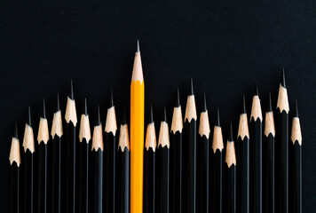 Yellow pencil standing out from the crowd