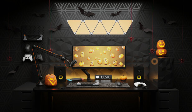 A general view of a gamer's home workplace with a computer and a gamepad decorated with decorations for the Halloween holiday.