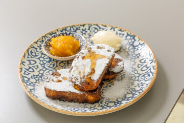 French toast served with peach jam and sugar