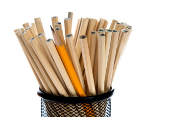 One yellow pencil standing out from the brown pencils