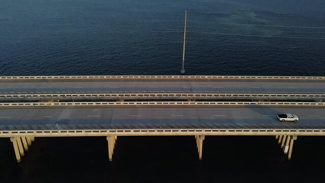 View of Seven Mile Bridge with passing cars. Monroe County, Florida, United States.