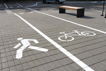 Marking for pedestrians and bicycles on the pavement tiled.