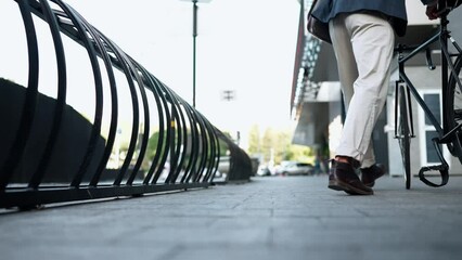 Attitude man wearing jacket riding a bicycle near building outdoors